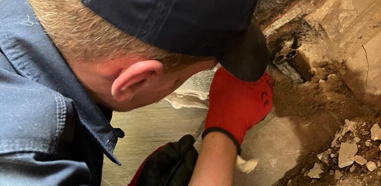 Expert plumber on site working on a pipe repair