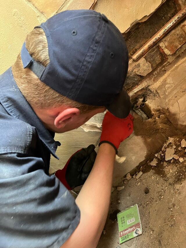 Expert plumber on site working on a pipe repair