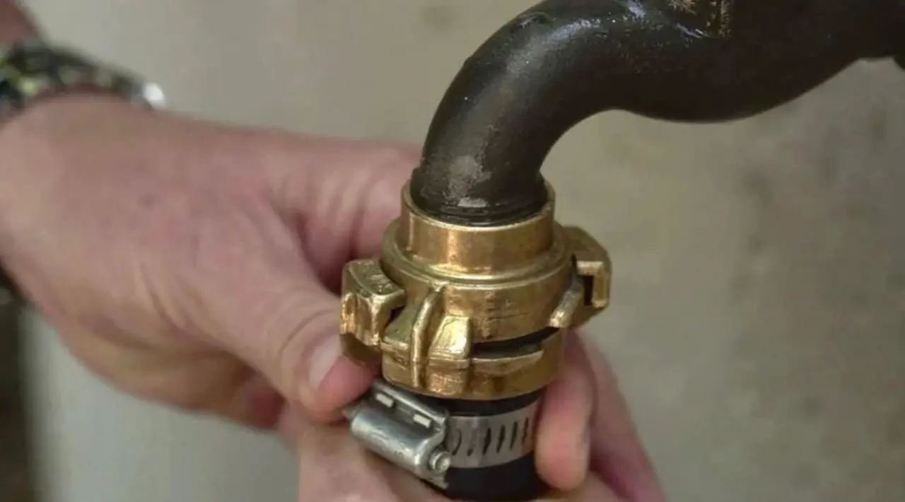 plumber connecting a water pipe fitting