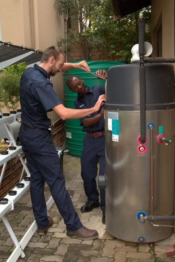 Technicians installing an energy-efficient hot water system