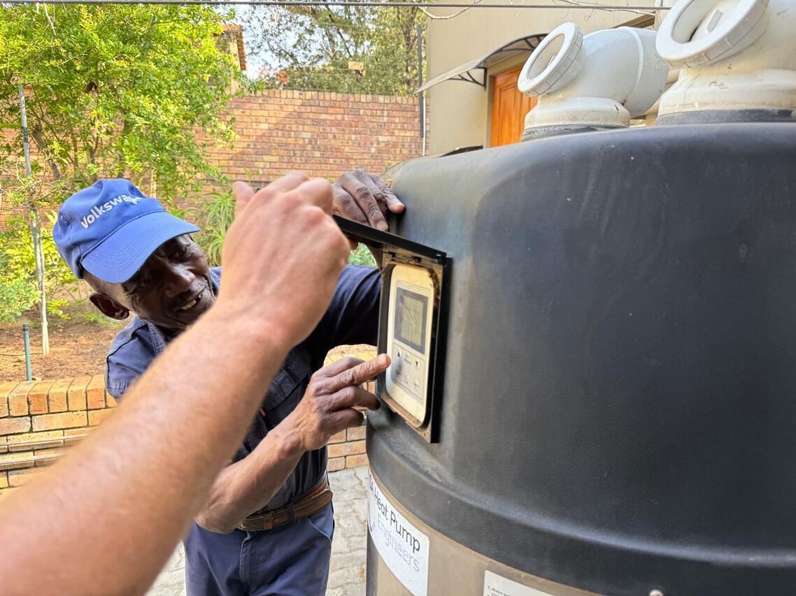 Alpha Plumbing technicians installing a heat pump system